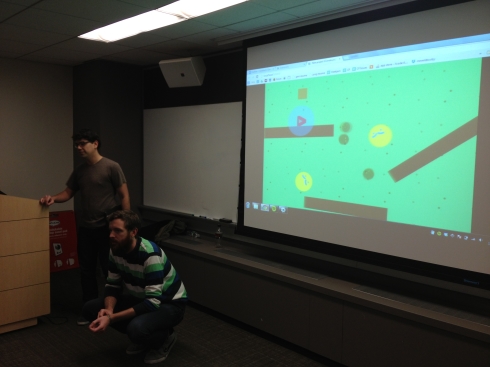 Studio Mercato's Chris Hernandez (standing) and Jon Stokes (action crouching) show off an example Construct 2 project.